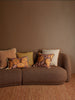 Gem Mustard 50cm Cushion styled