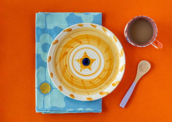 ceramic hand painted side plate yellow sun design navy centre  white background