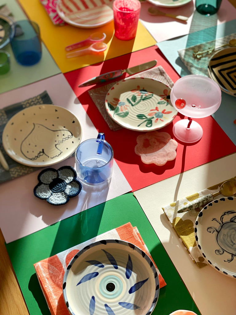 Jumbled Robert Gordon collaboration of hand painted ceramic side plates mix and match tablescape